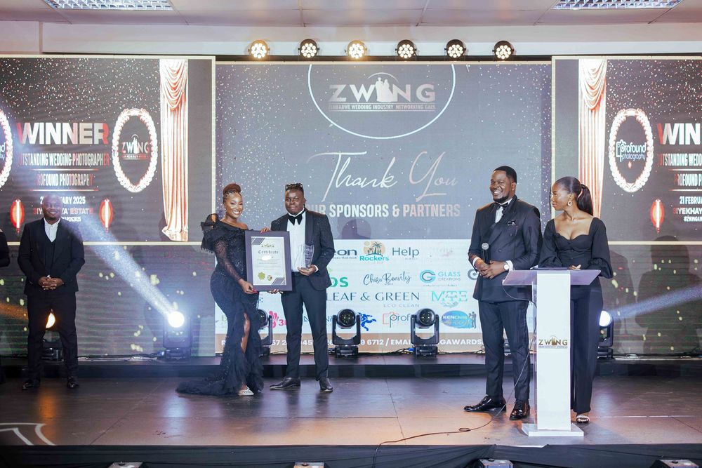 Awards ceremony on stage with presenters and recipients at an event with illuminated backdrop displaying Zweing branding.