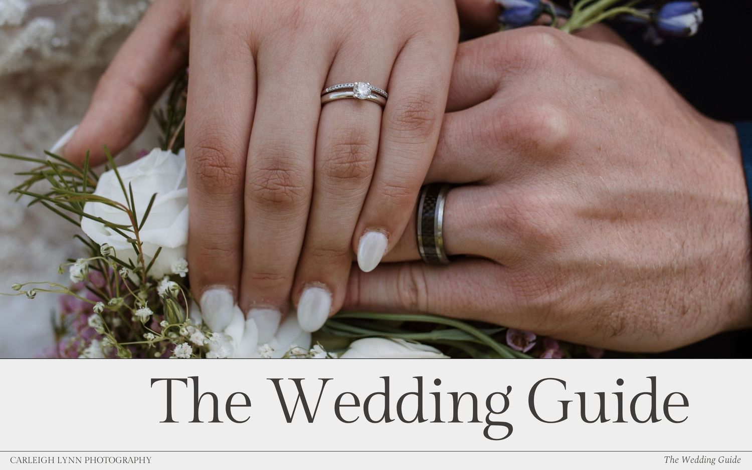 Close up of newlyweds' hands with wedding rings holding a beautiful bouquet of pink and white flowers with delicate greenery.