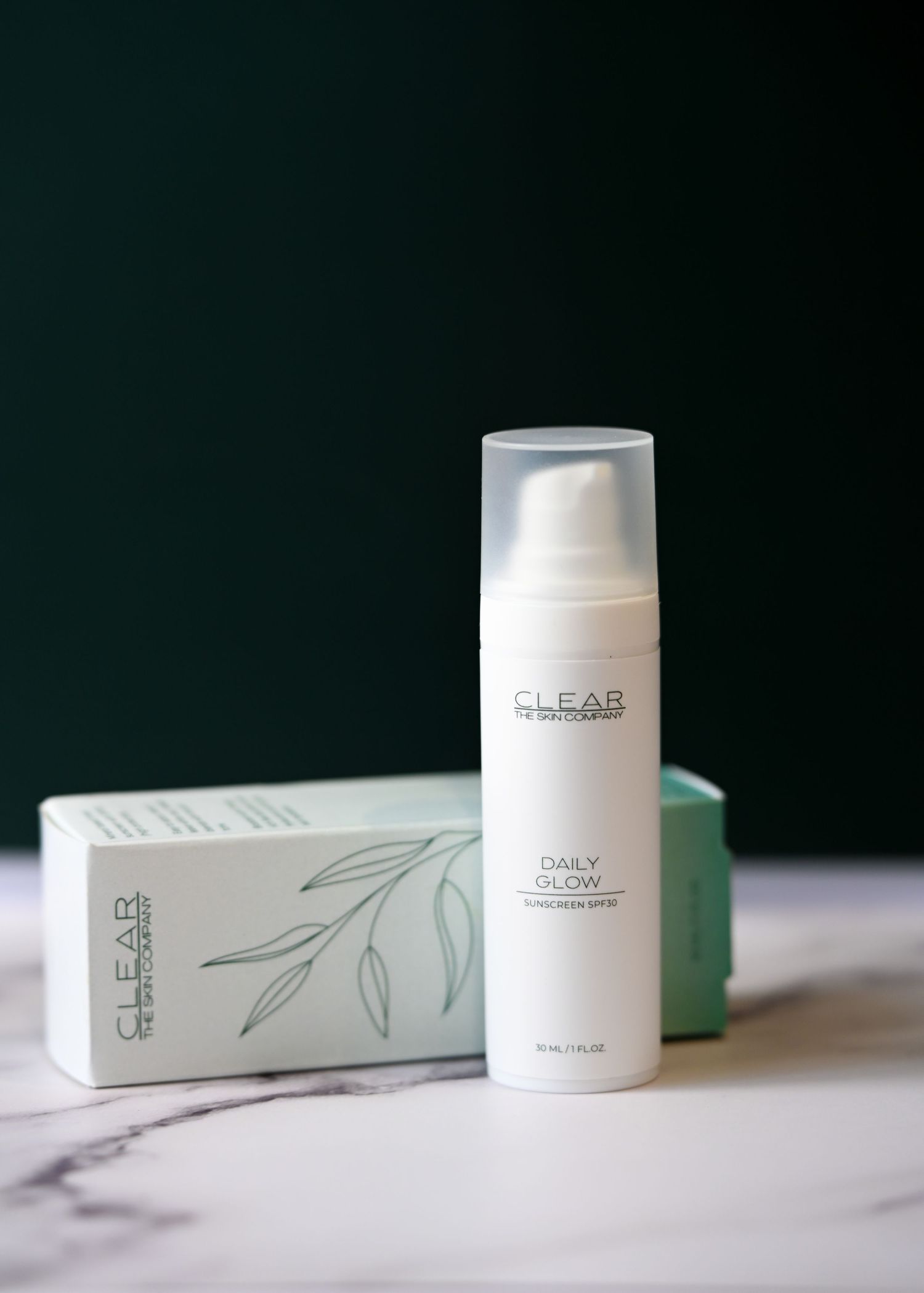 CLEAR The Skin Company Daily Glow facial radiance spray in white airless bottle with teal product box.