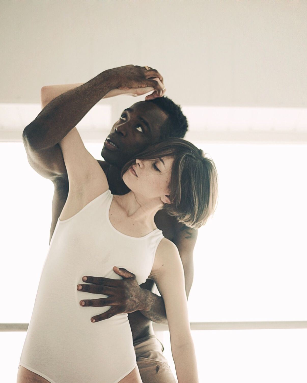 Artistic dance photo capturing intimate movement in natural light.