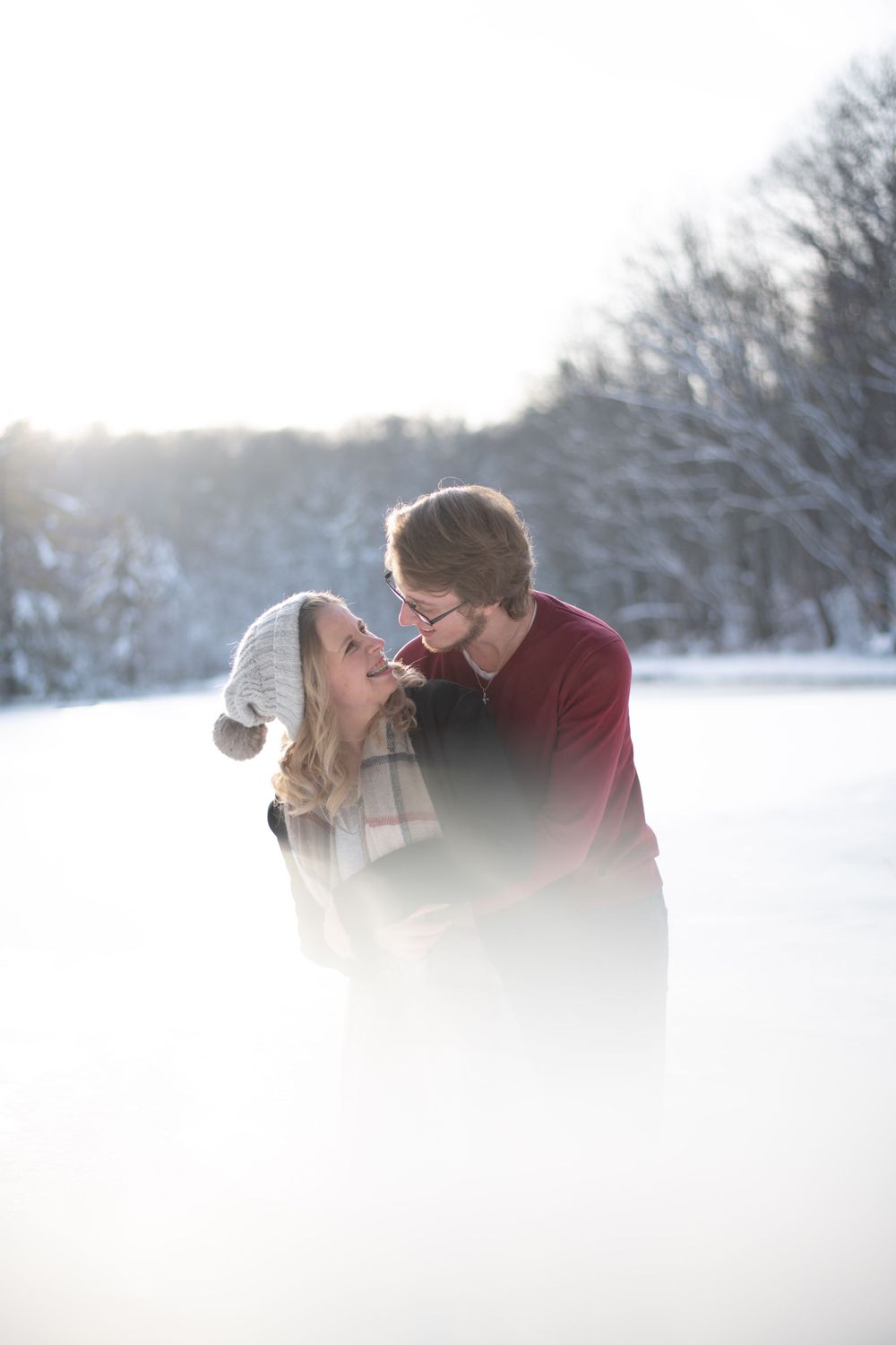 A dreamy winter portrait of a couple sharing an intimate moment in the snow.