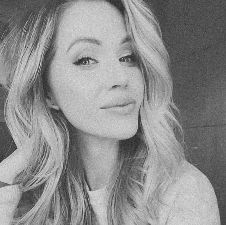 Black and white selfie portrait with soft natural lighting.