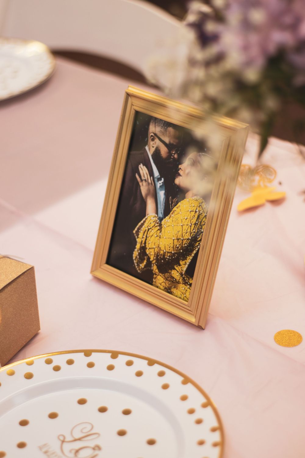 Table setting with pastel florals, desserts, and bridal shower favors