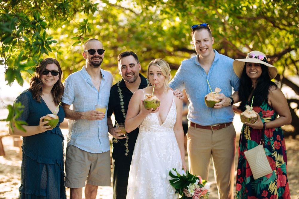 Wedding celebration with guests enjoying drinks and food in an outdoor garden setting.