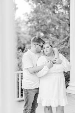 Black and white portraits capture intimate moments between couple on columned porch.