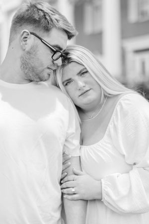 Black and white series captures intimate moments between couple on porch.