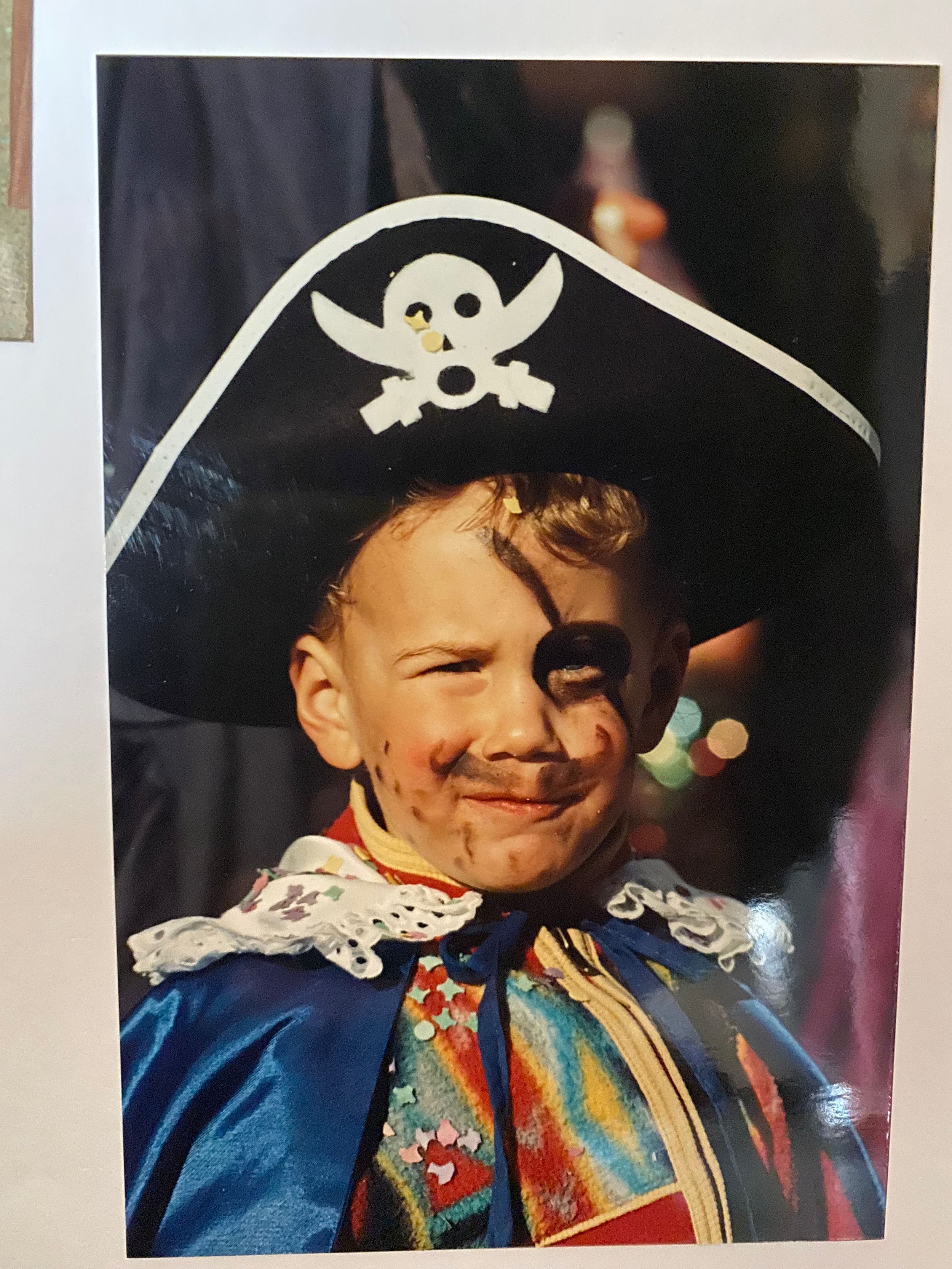 Young Joel Ducreot wearing a pirate costume with hat and colorful jacket.