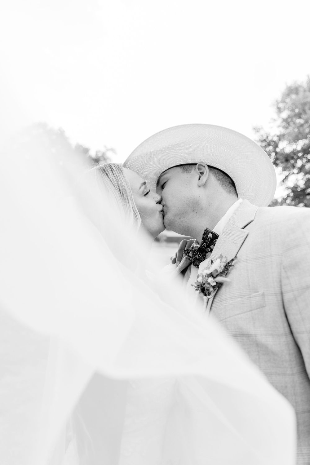 Intimate black and white close-up of romantic wedding moment.