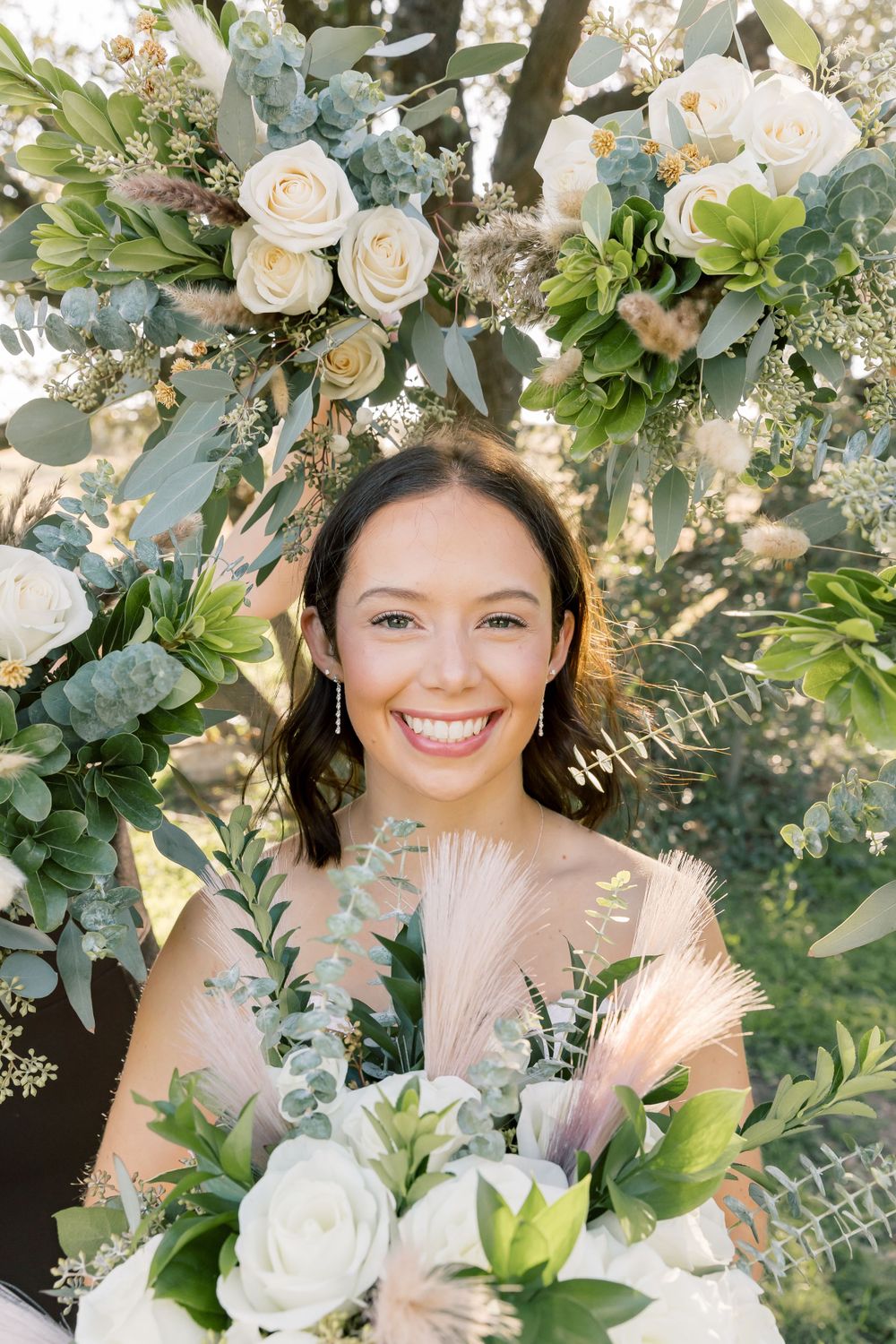 Elegant wedding photo collage with white roses, greenery and eucalyptus creating a romantic floral frame.