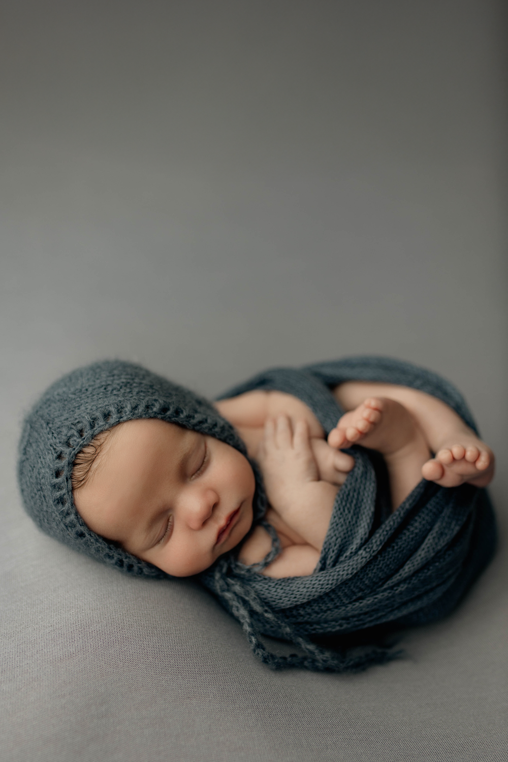 bonnet and wrap newborn pose