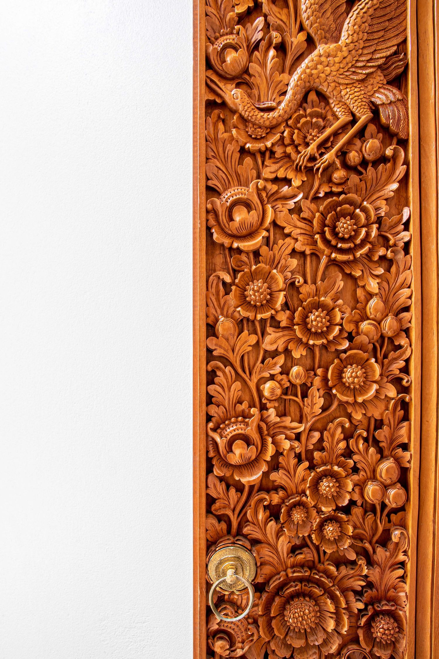 Elaborate carvings on a wooden panel, representing artisan craftsmanship in interior design