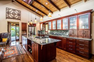 Elegant kitchen with wooden cabinets and a rustic yet luxurious feel in a Costa Rica home