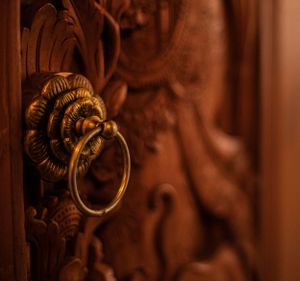 Close-up of a detailed wooden door handle, reflecting artisan craftsmanship in real estate design