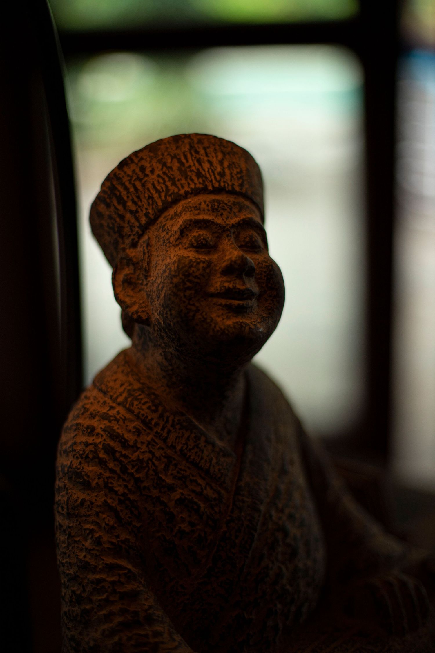 Carved wooden Buddha statue, adding a serene and spiritual touch to the interior design