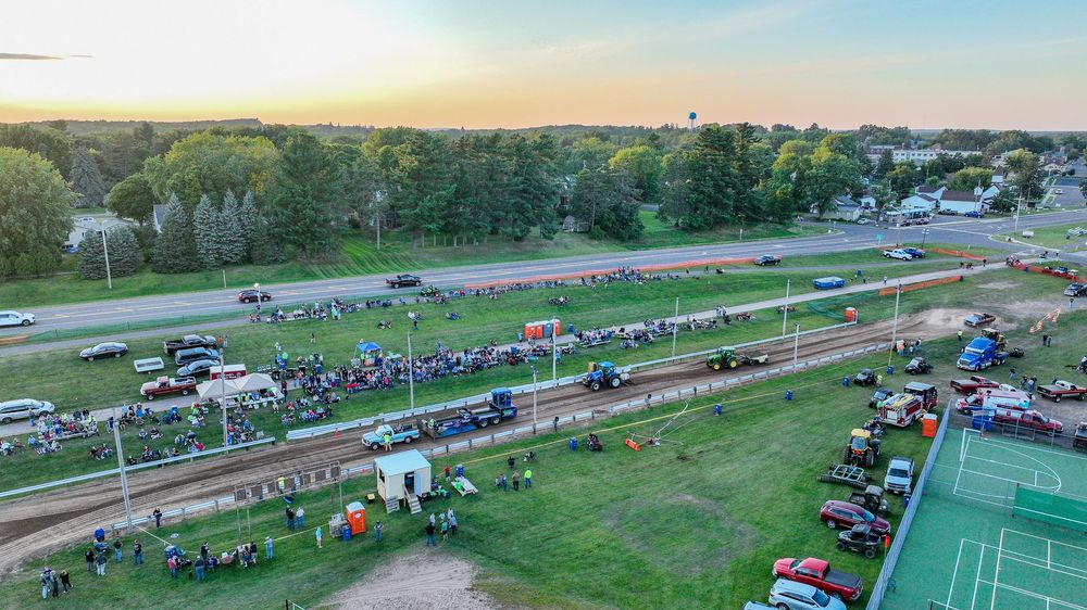 Truck Pull Town and Country Days Shell LakeAerial view of a packed truck and tractor pull event at twilight with large spectator crowds.