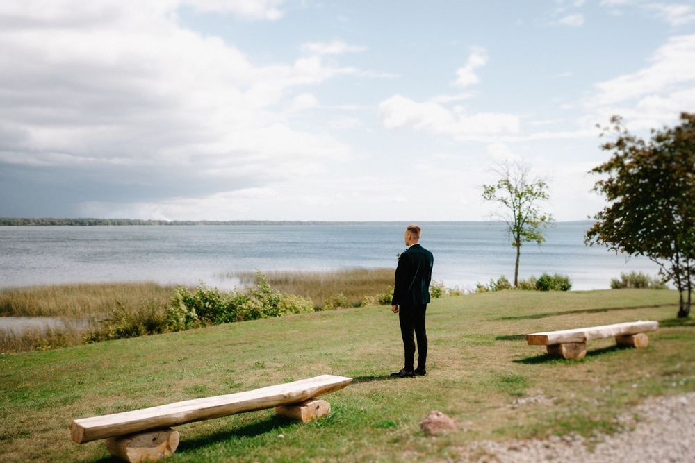 Scenic waterfront wedding location with wooden benches overlooking the ocean.