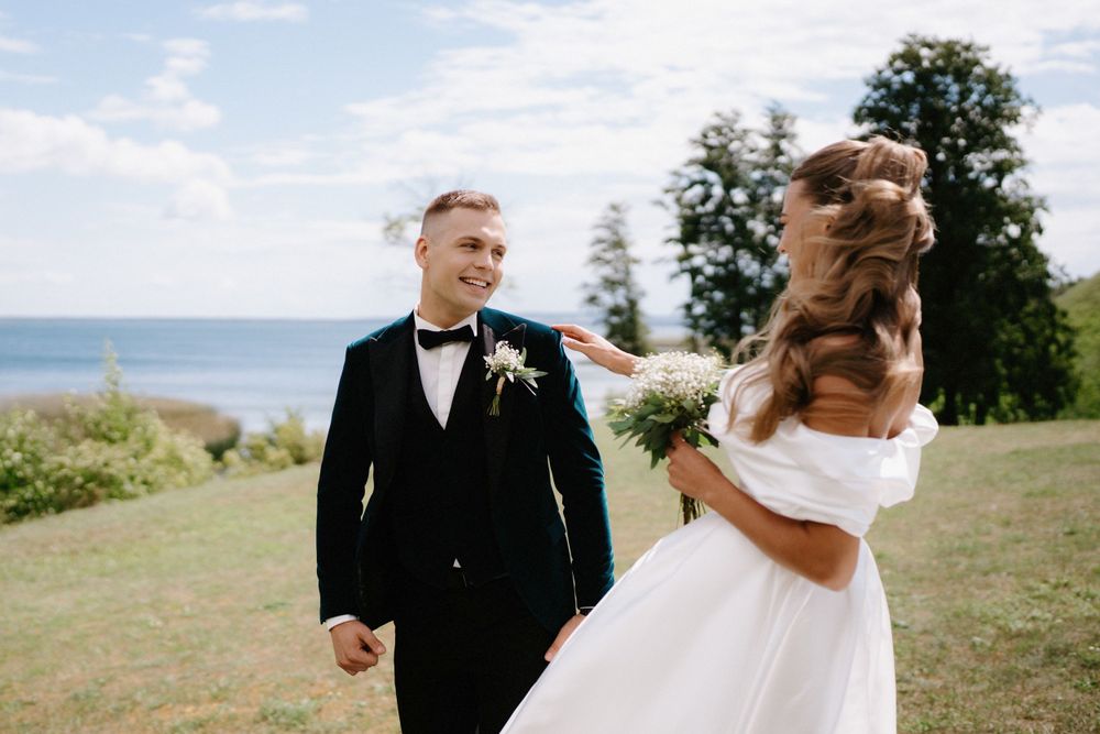 Candid wedding moments captured against a bright blue sky with trees in background.
