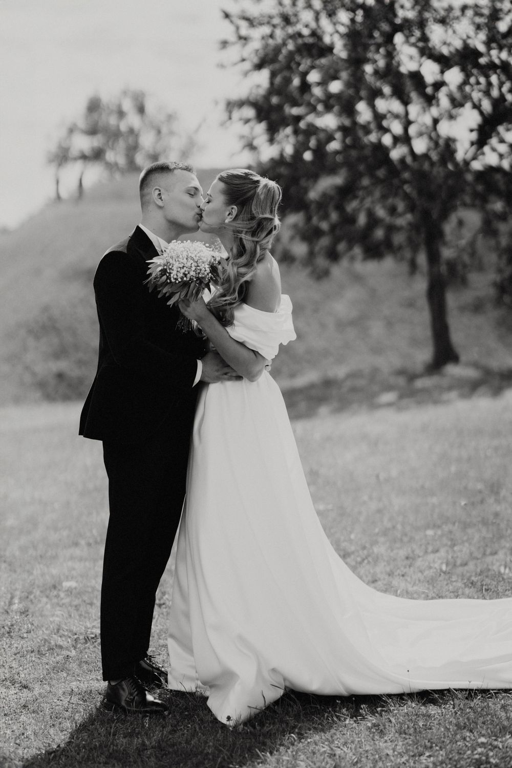 Intimate black and white wedding portraits in a natural outdoor setting.