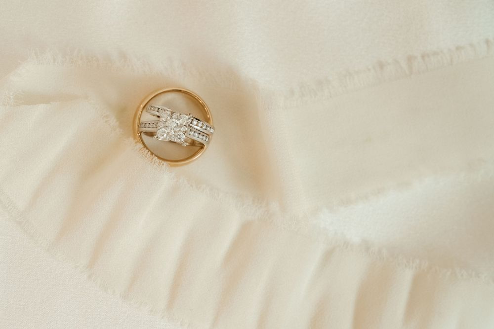 Close-up of wedding rings on a light textured background with soft focus.