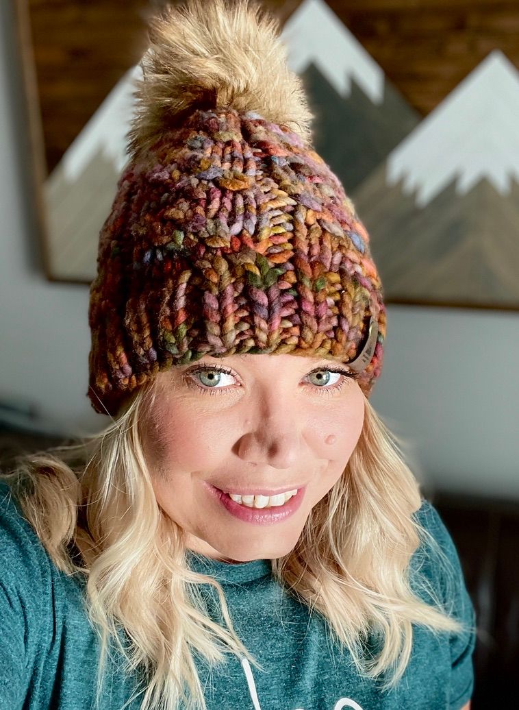 Series showing a cozy winter look with a multicolored knit beanie and teal sweater.