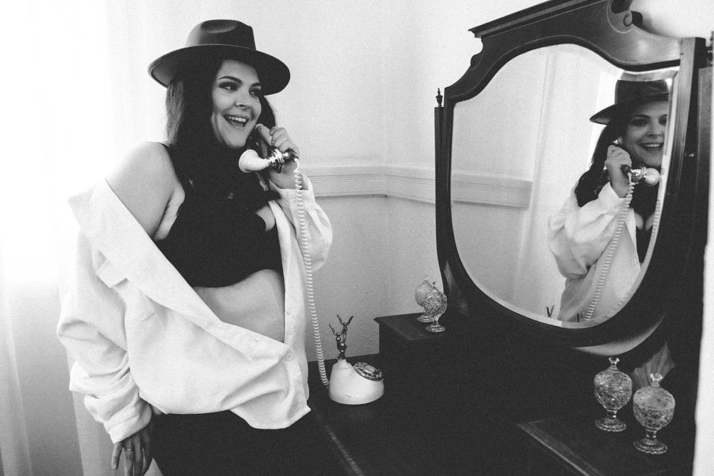 Classic black and white photo with vintage mirror and white shirt styling.