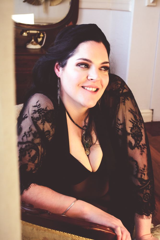Elegant portrait with black lace and natural window lighting in vintage setting.