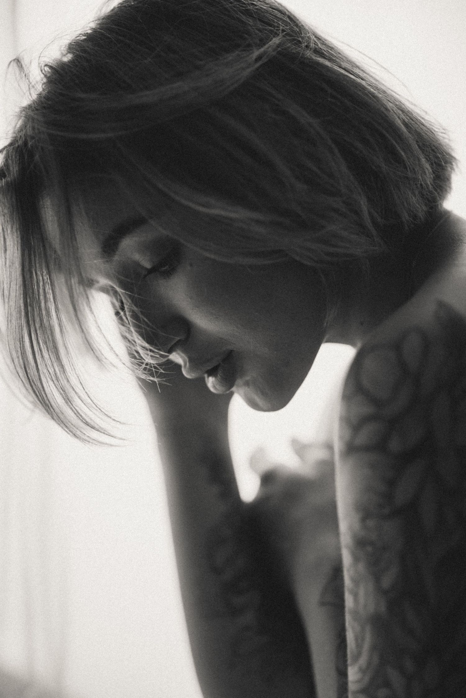 Monochrome portrait series showing contemplative poses in soft lighting.