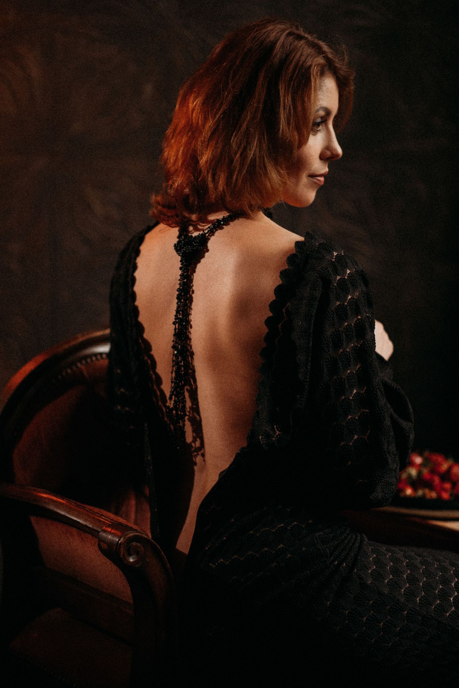 Elegant portrait series featuring a black lace dress with open back detail.