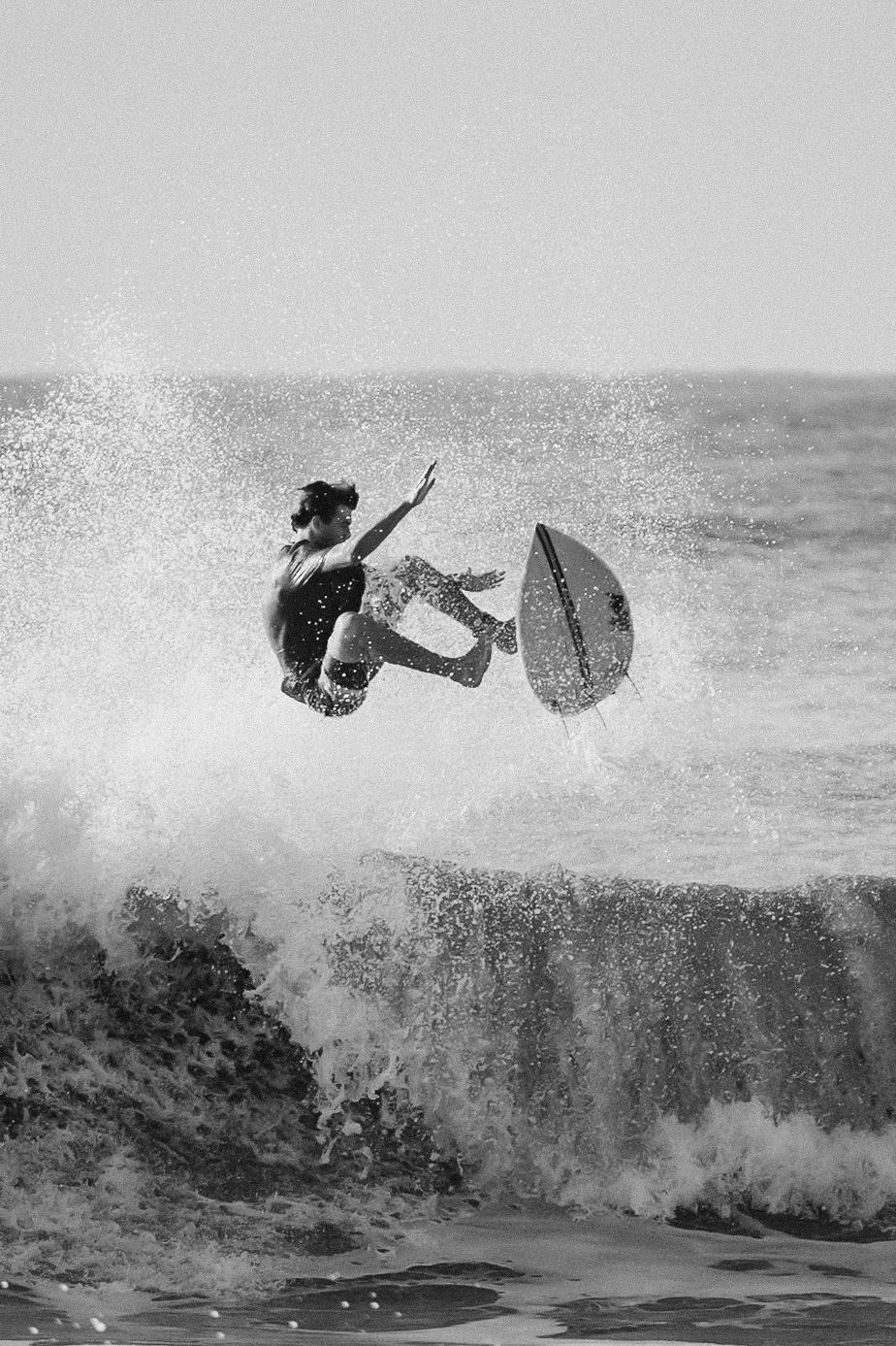 A sequence of a surfer wiping out and being thrown from their board while riding a large ocean wave.