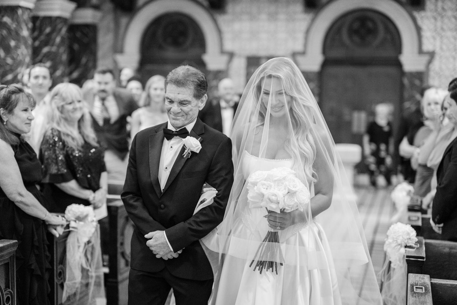 A bride and groom share an intimate moment during their wedding ceremony in a beautiful church setting.