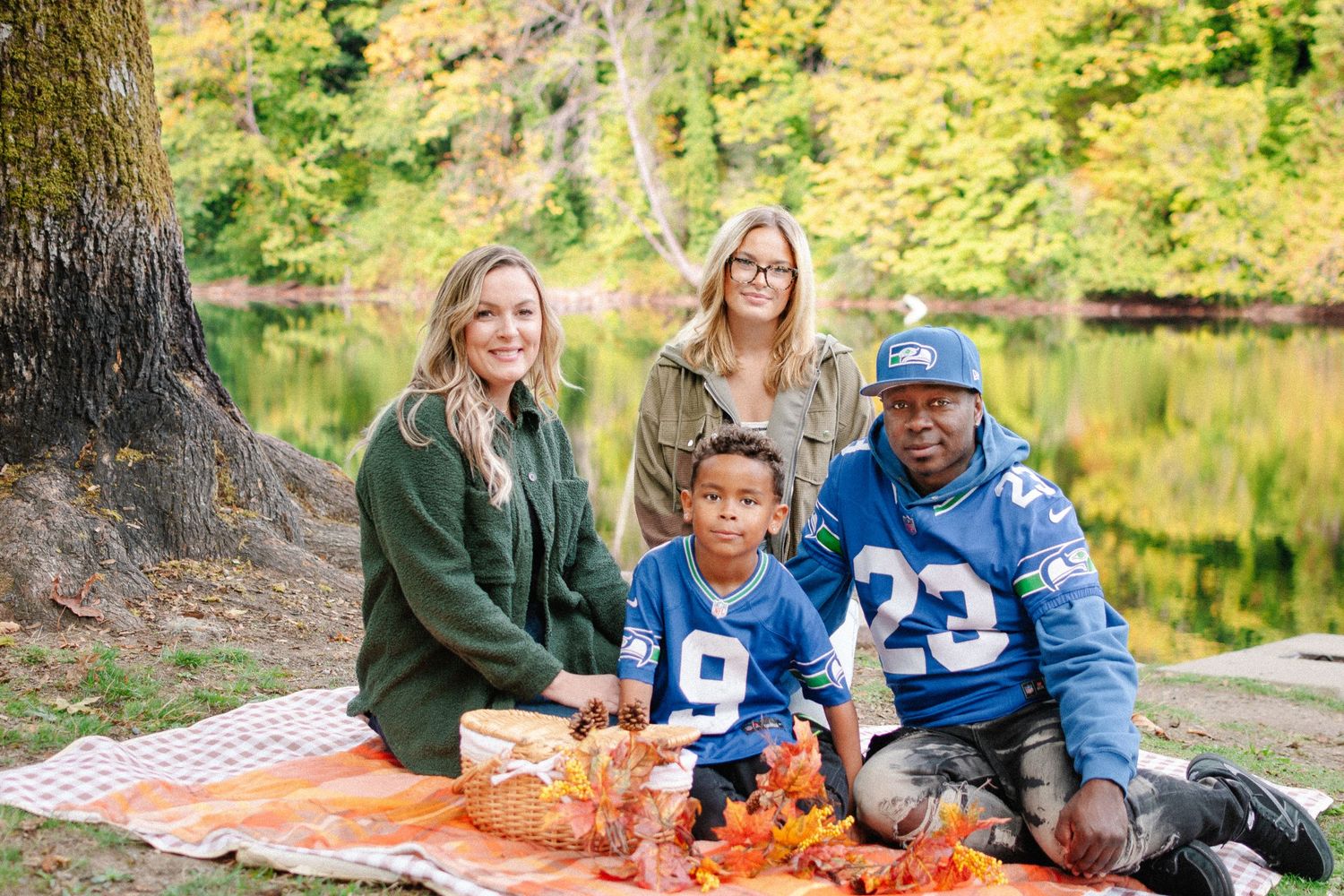 Family wearing Seattle Seahawks jerseys during a fall photo session at Lake Fenwick Park in Kent, located between Seattle and Tacoma.