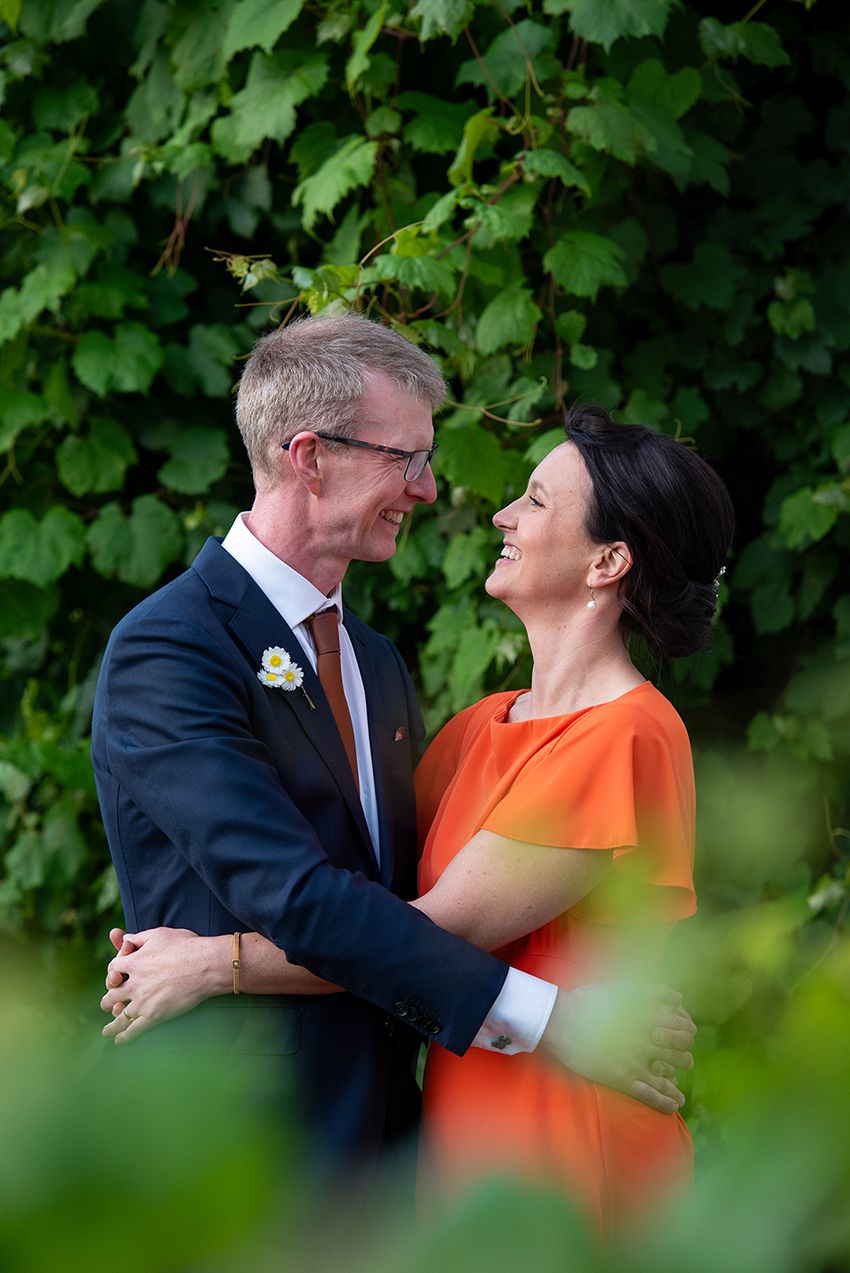 bride and groom photographed through bushes - Kelly Chapman Photographer Perth