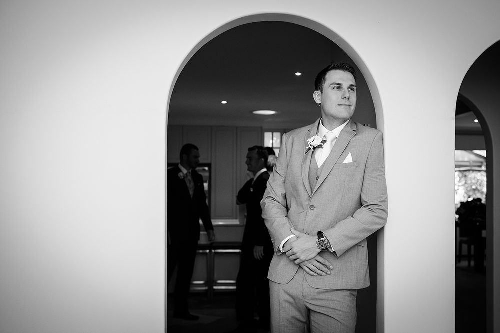 Black and white groom portrait in archway - Kelly Chapman Photographer Perth