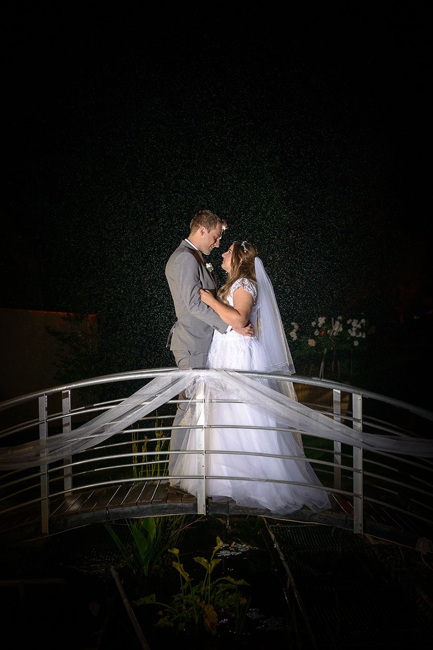 Bride and groom on bridge in rain - Kelly Chapman Photographer Perth