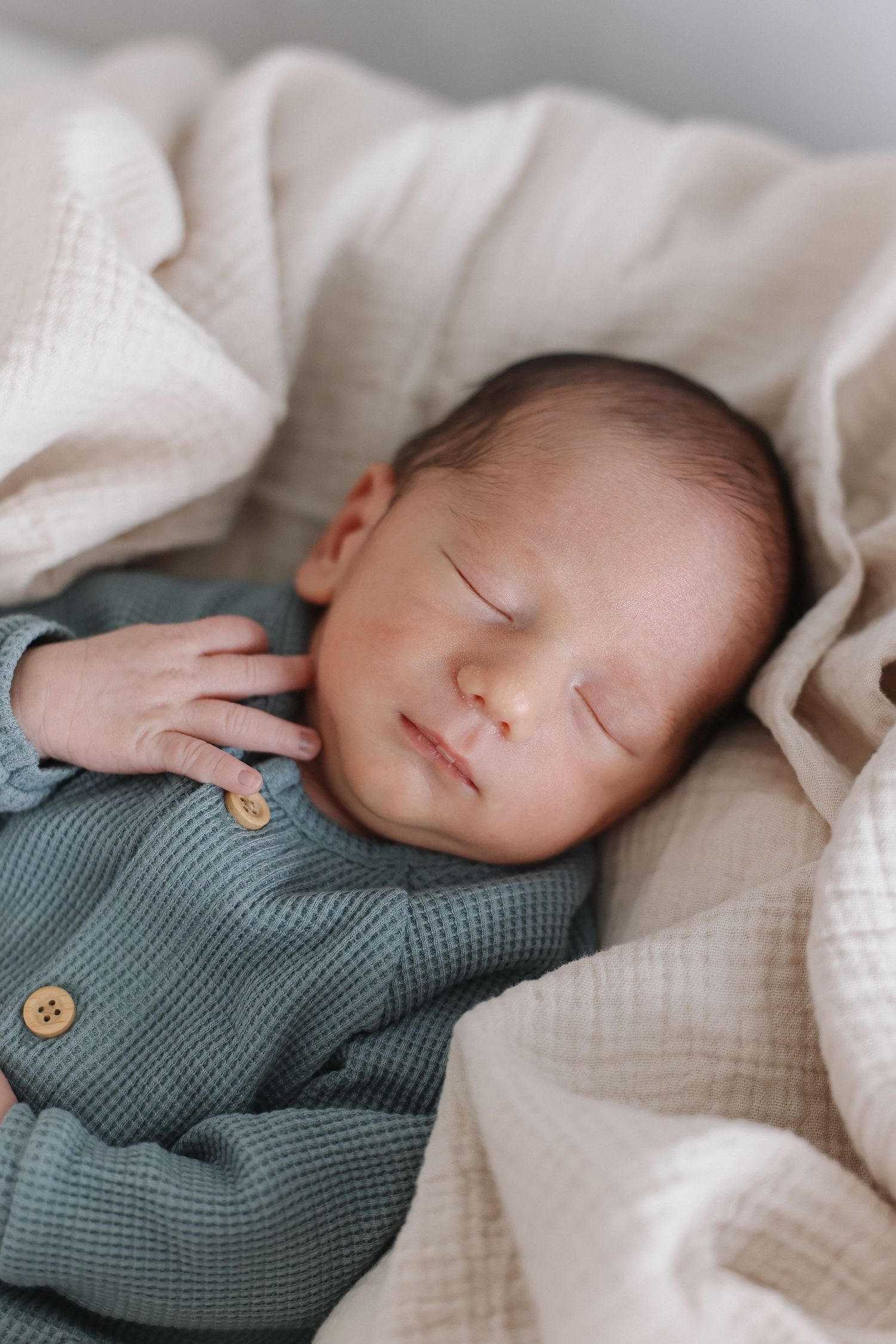 Newborn detail photograph showing soft wrinkles on baby feet in California