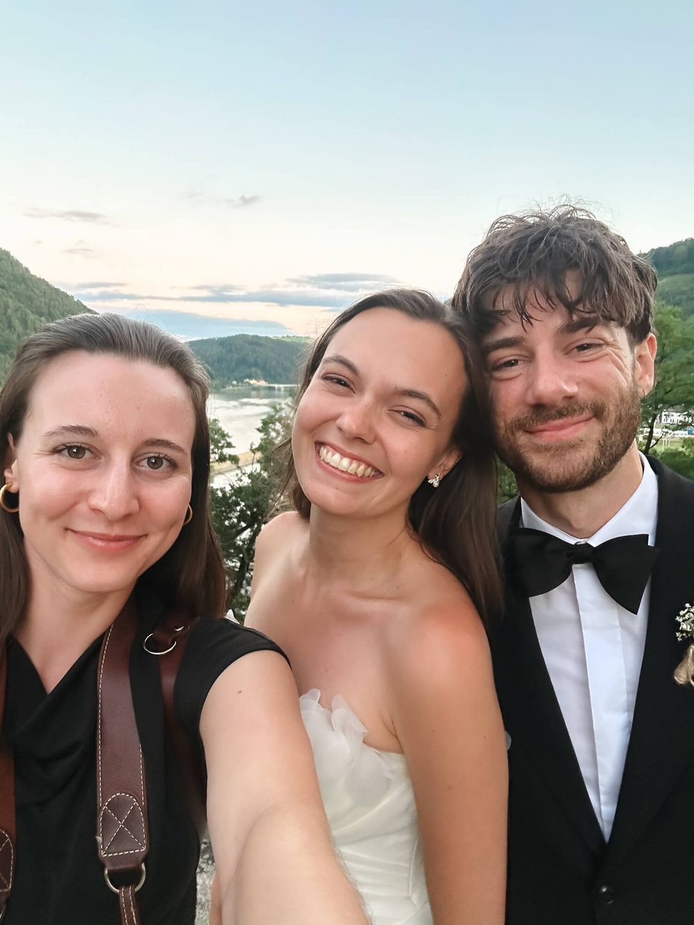 A selfie of a photographer with a freshly married couple.