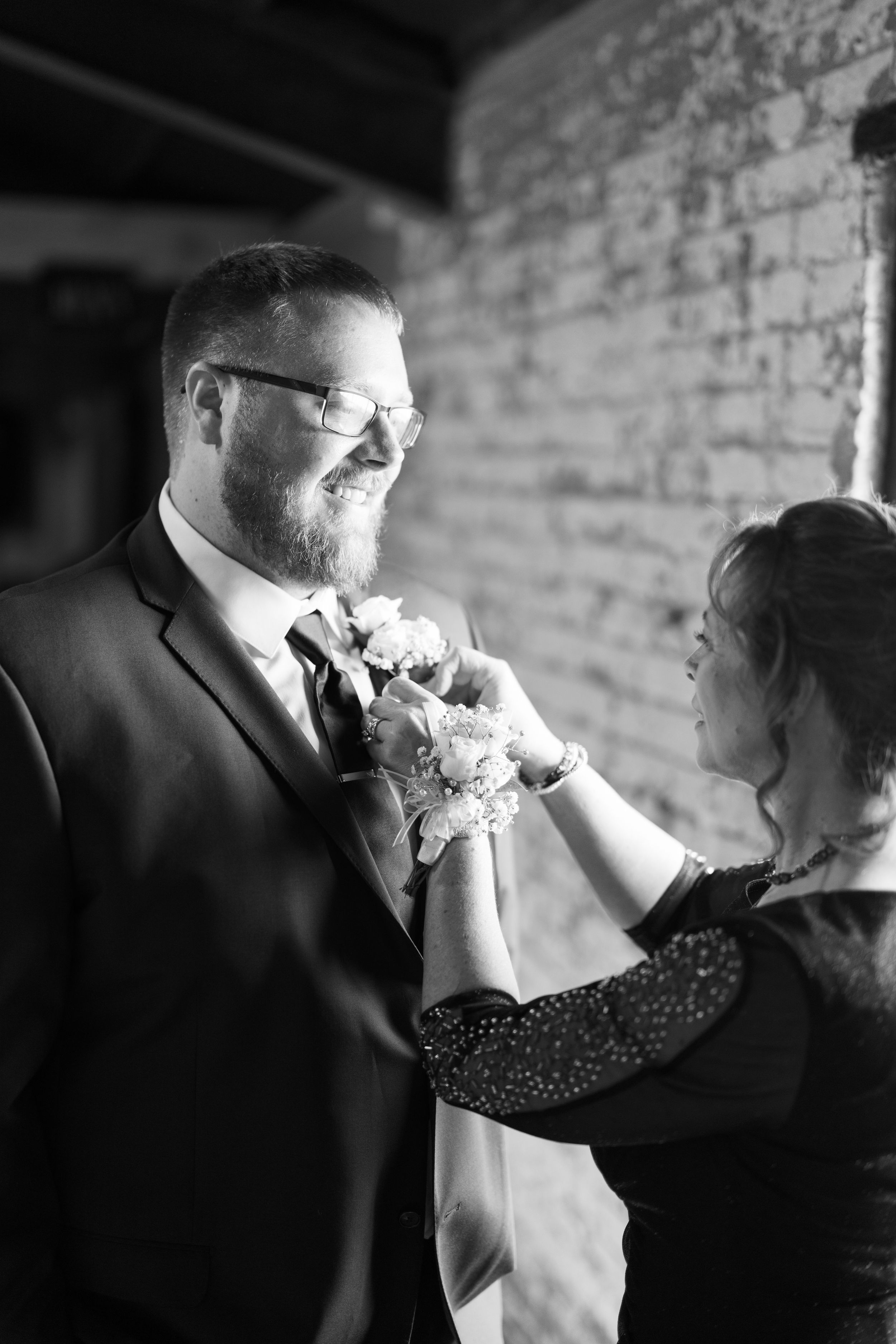 Black and white photo series showing a couple dancing together in an intimate moment at a formal event.