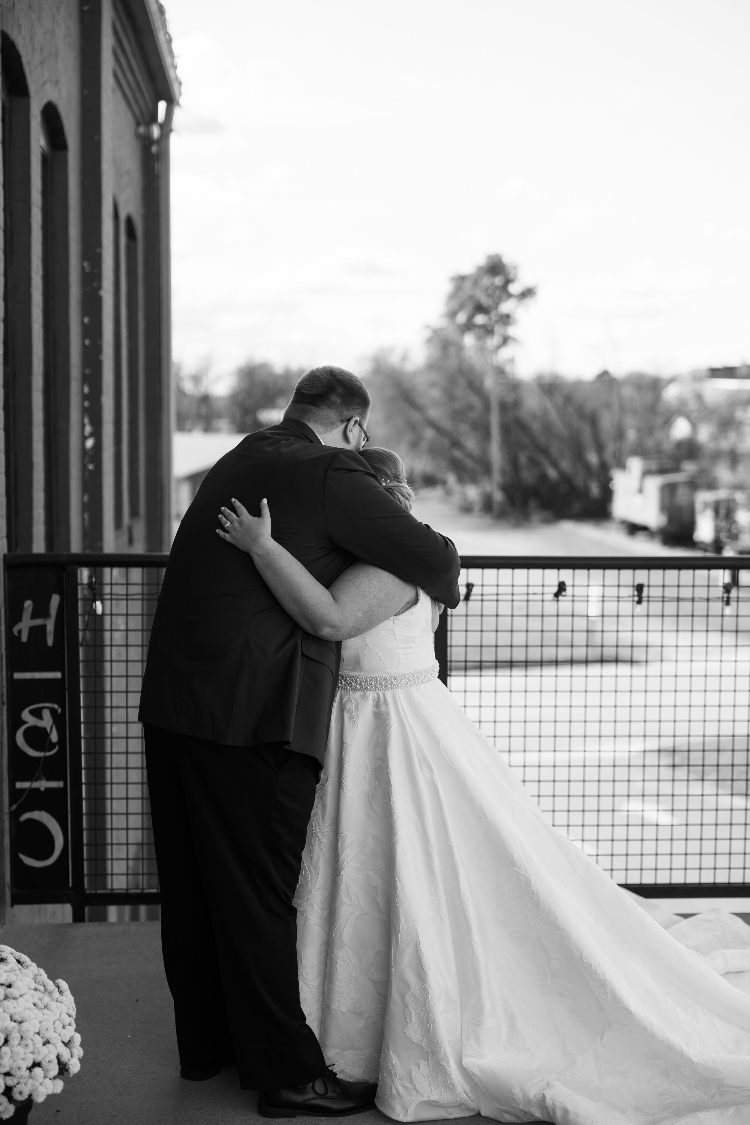A romantic black and white wedding photo sequence shows a couple sharing a kiss on a porch with a white dress flowing.