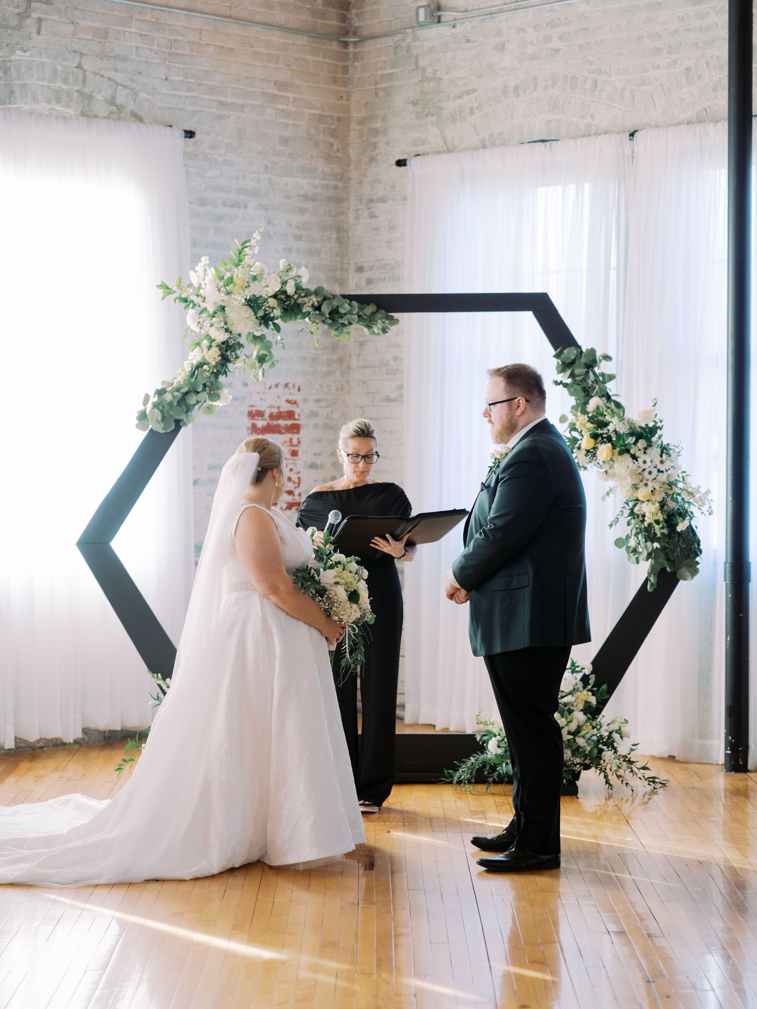 A wedding ceremony sequence showing multiple angles of a couple exchanging vows in a bright, modern venue with white walls.