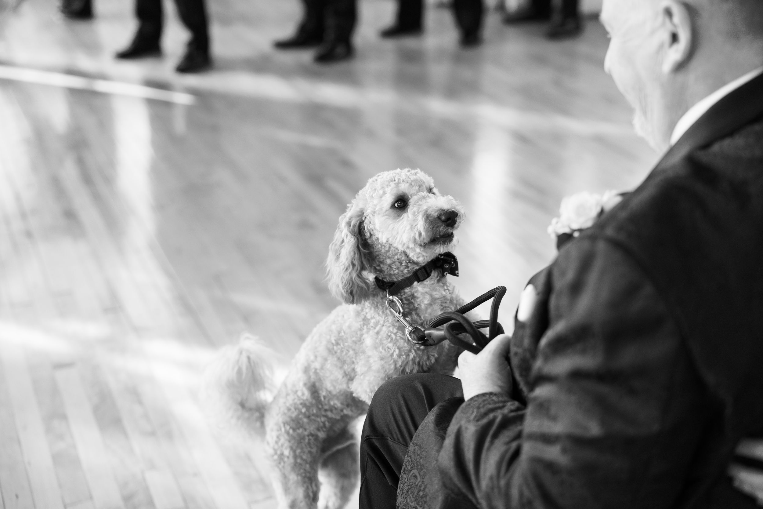 A group of people gathered in a black and white photograph with a vintage aesthetic.