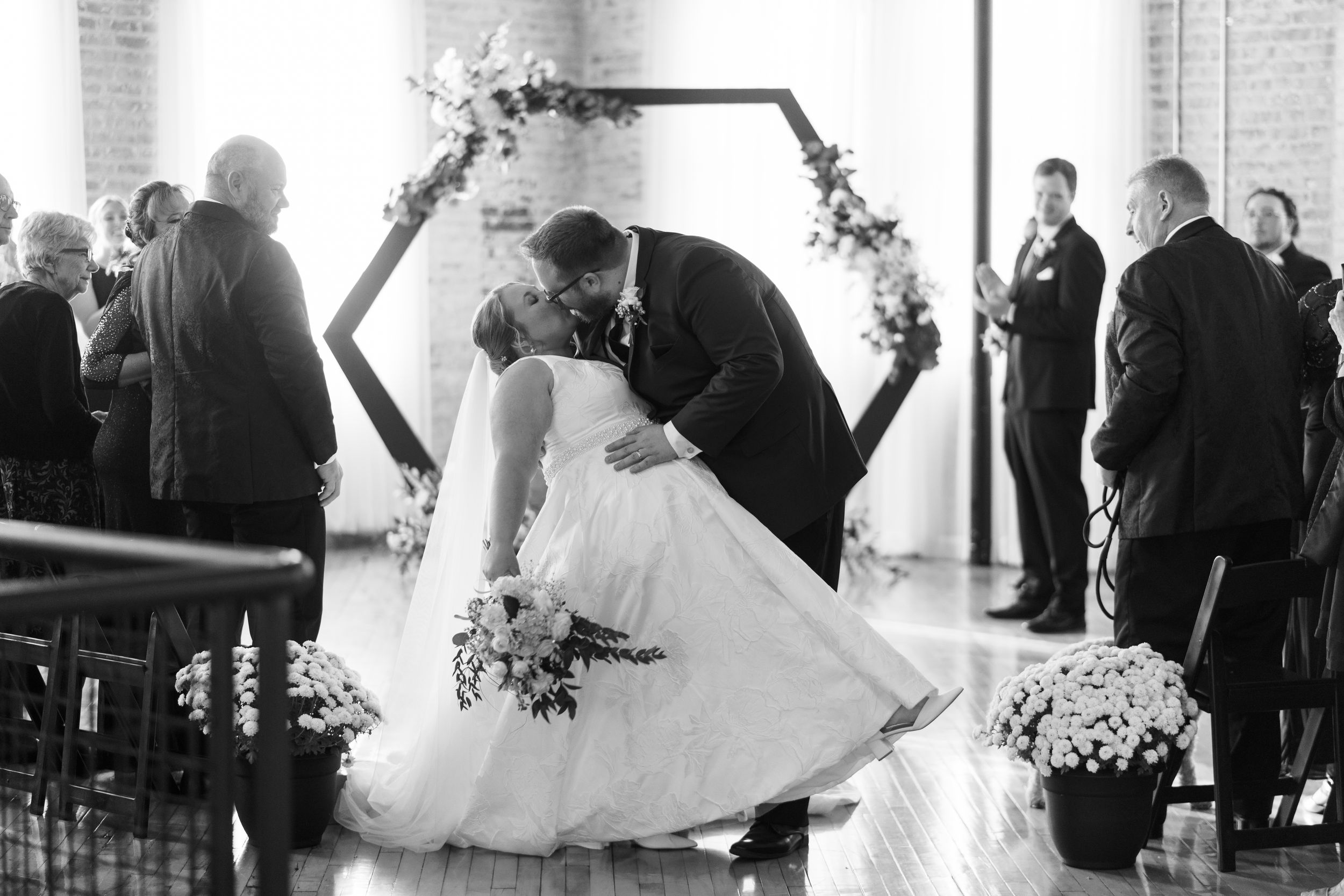 A series of black and white wedding photos showing guests and couples dancing at an elegant reception celebration.