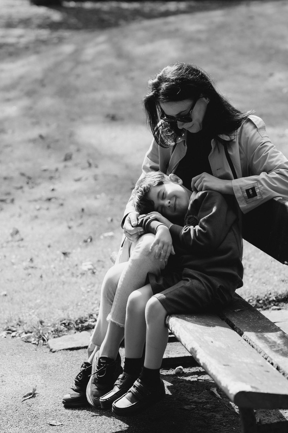 A black and white photo sequence shows a person sitting on the ground and gradually leaning over to rest.