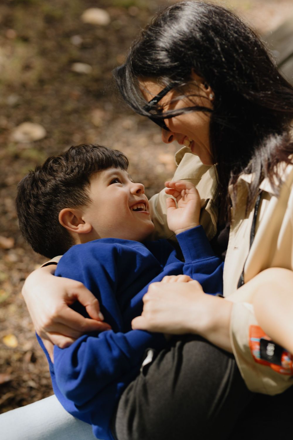 A heartwarming sequence shows a tender embrace and playful interaction between parent and child outdoors.