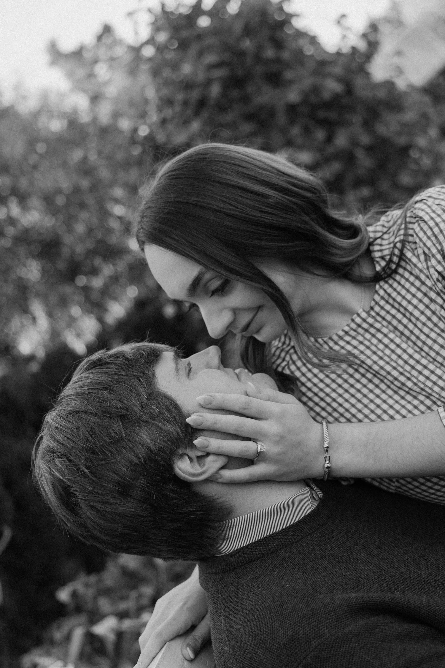 A romantic black and white sequence showing a couple sharing tender kisses in an outdoor setting.