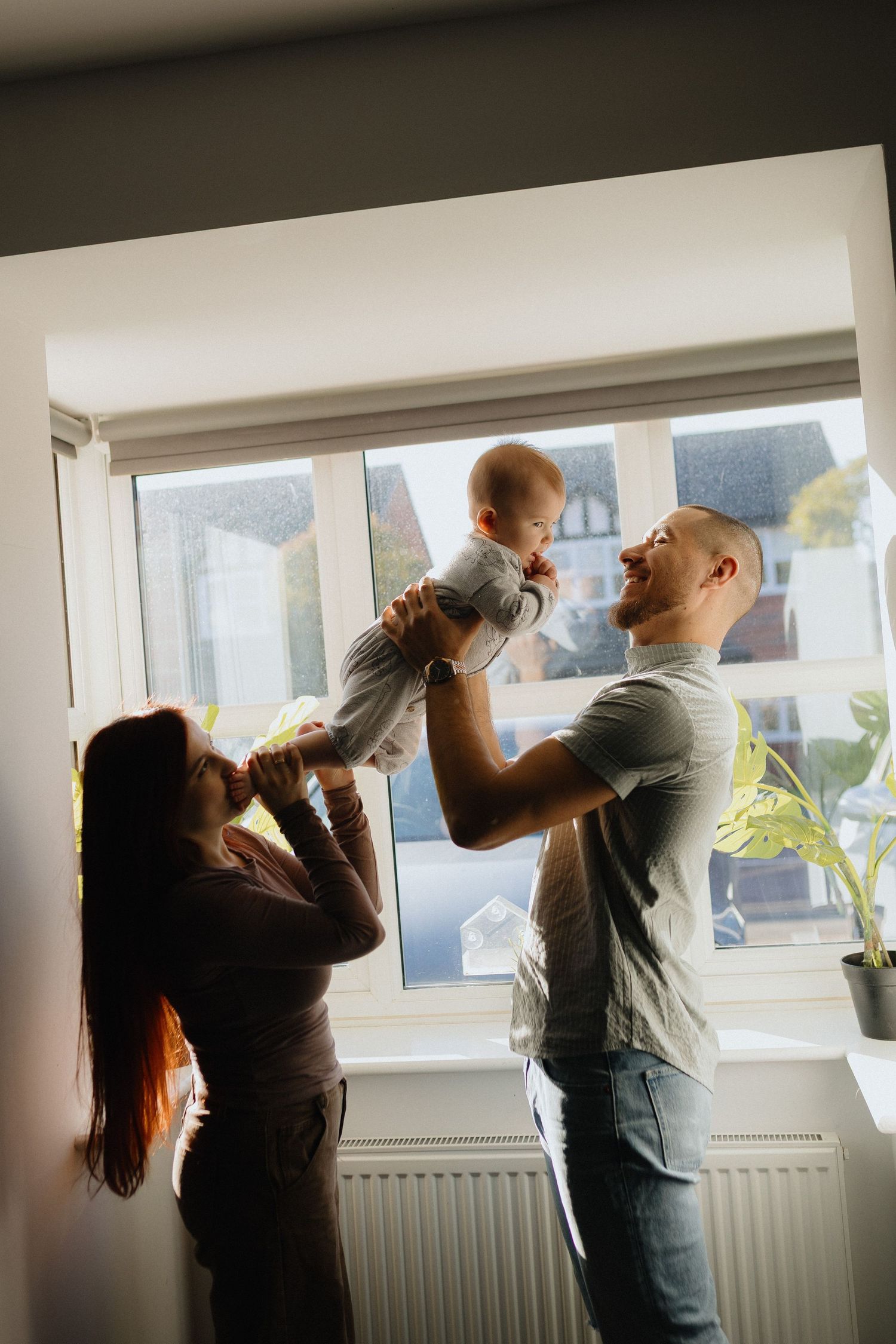A sequence of photos showing a couple dancing together by a window in a romantic moment.