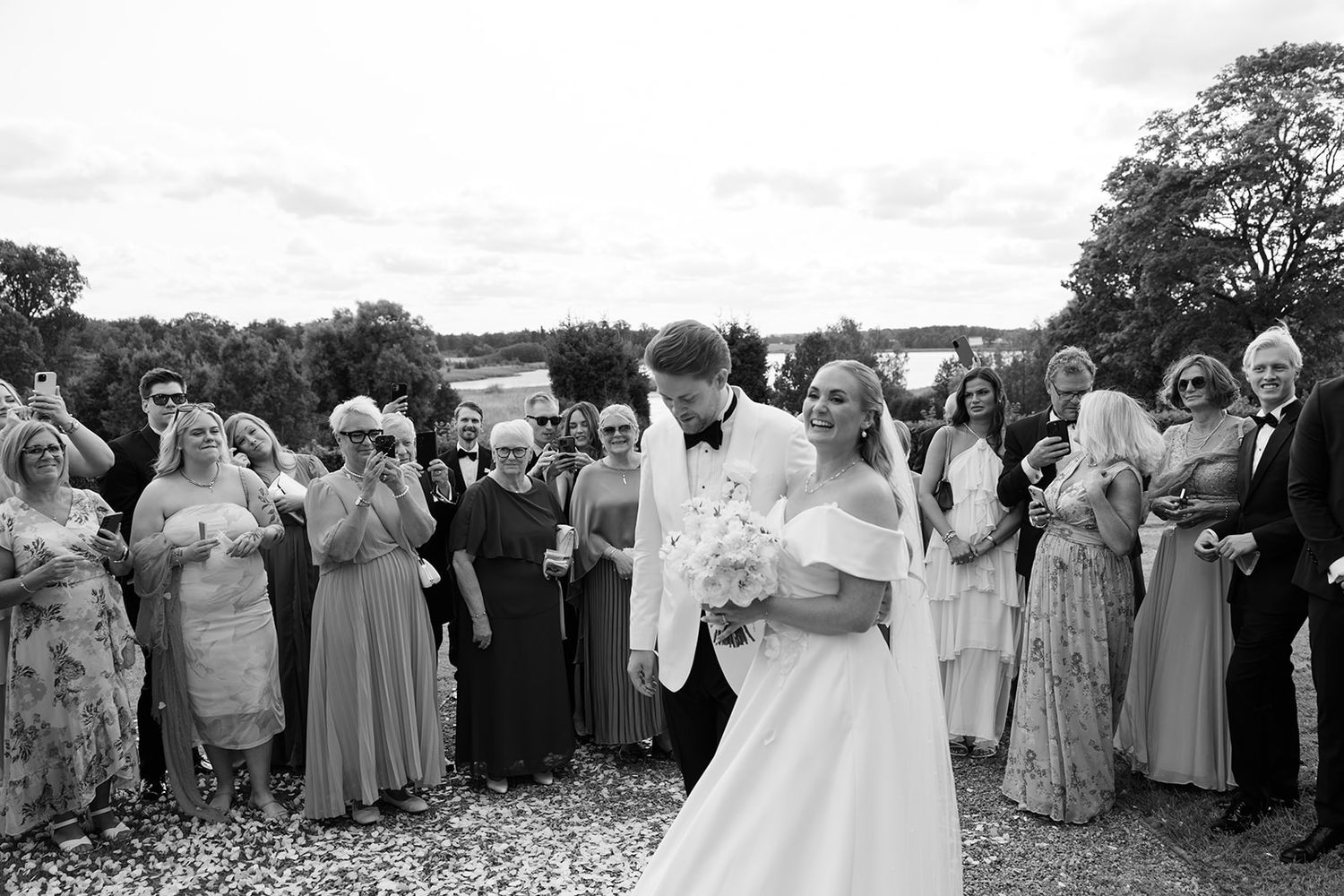A black and white wedding photo collage showing joyful moments of celebration with confetti and dancing.