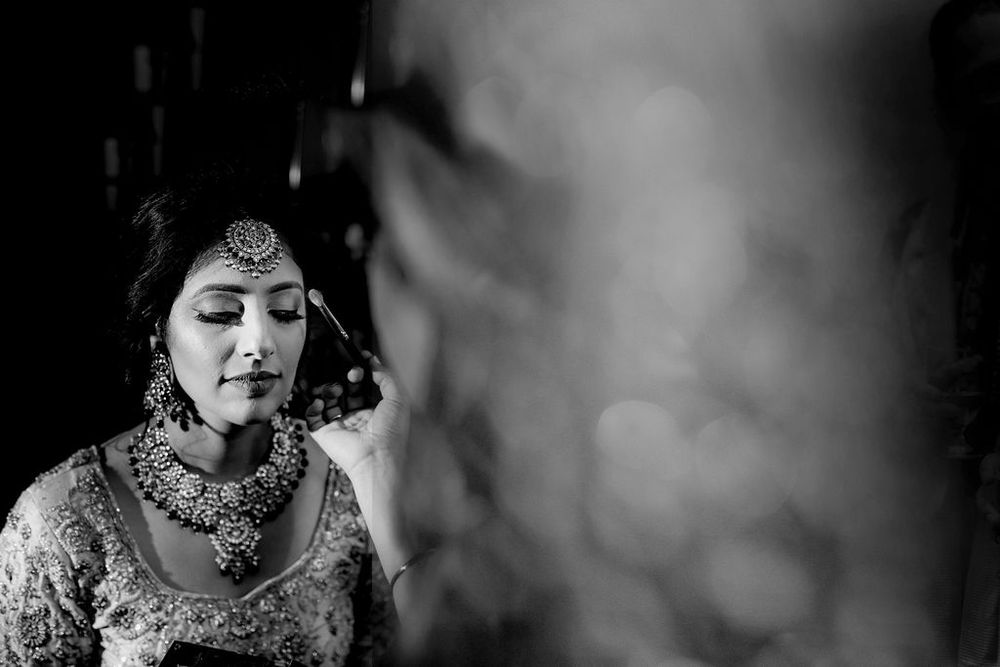 Black and white portraits of a bride in traditional Indian wedding attire with elegant jewelry and makeup.