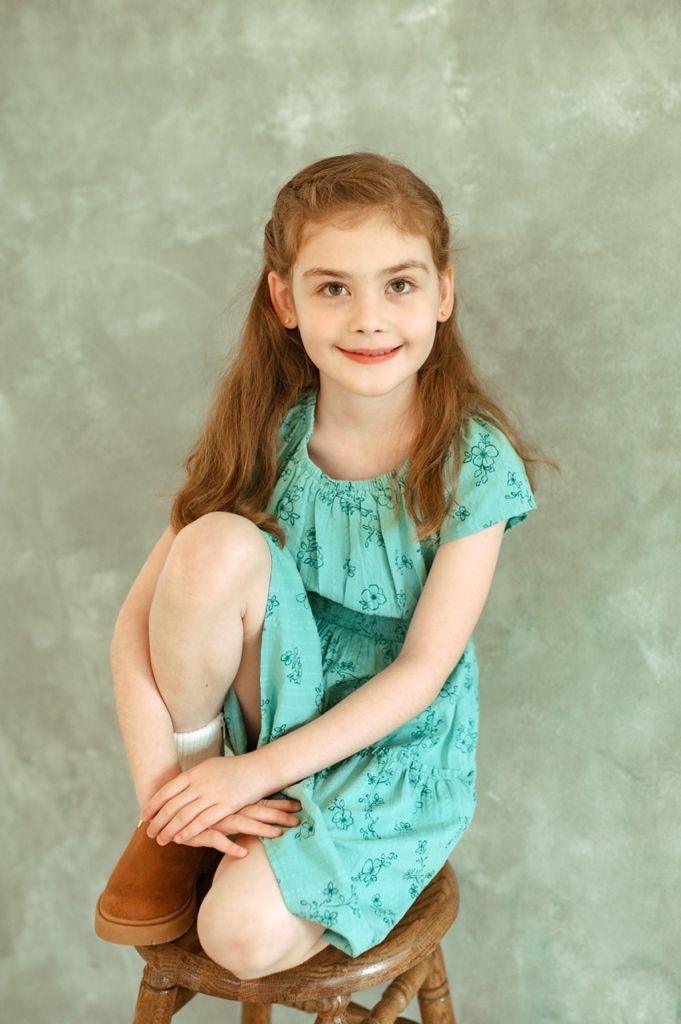 A collection of portrait shots featuring a mint green sleeveless dress against a textured grey background.