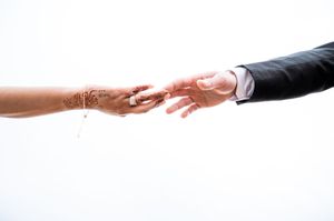 Series of artistic black and white photos showing hands reaching toward each other.