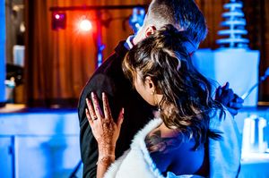Wedding reception dance floor with blue and red mood lighting creating dramatic atmosphere.